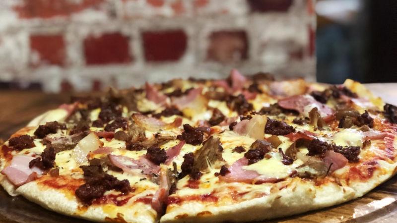 Delight your tastebuds with the flavors of Smoke House Queenstown's delicious brick oven pizzas! 
