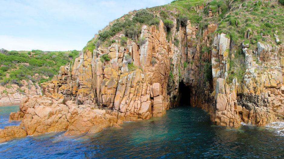 Discover Cape Woolamai's stunning views on Phillip Island, featuring impressive granite cliffs and caves, all surrounded by beautiful turquoise waters!