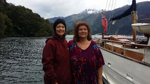 With Mum on our cruise. South Fiords in the background, untouched Fiordland bush on our right and 'Faith' on our left.