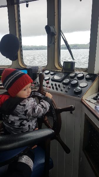 Got to steer the boat. Happy boy!!!